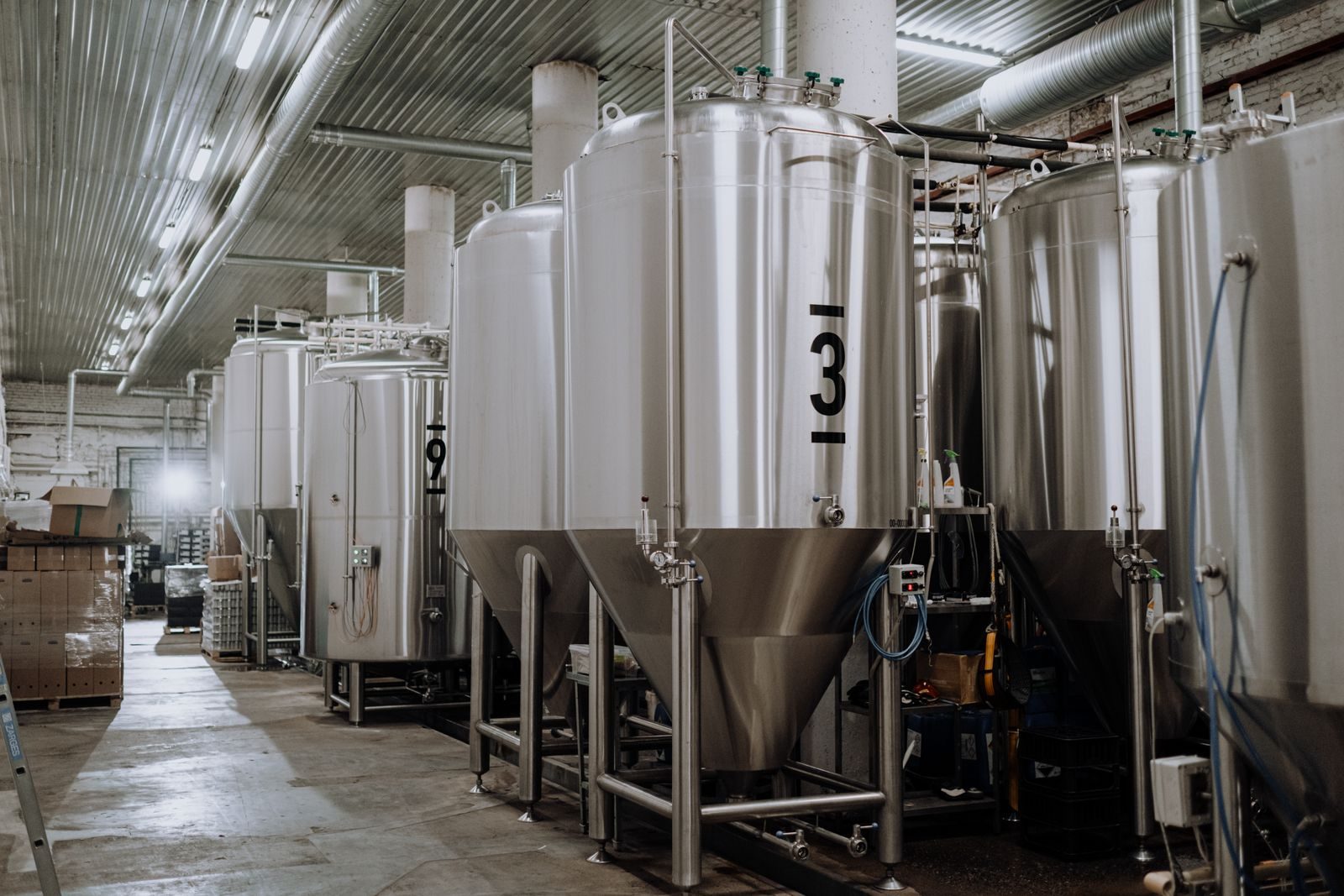 Stainless process tanks on a production floor
